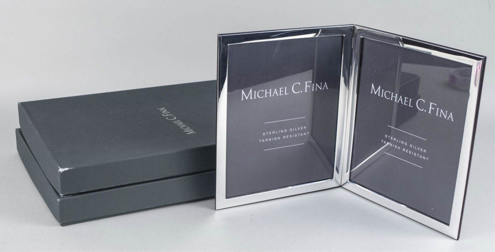 Pair of Michael C Fina Silver Picture Frames: Manhattan pattern double 8 x 10 frames. Notice to bidders: Due to the nature of this particular online sale, the lots offered may not be available for detailed condition reports or additional photogra