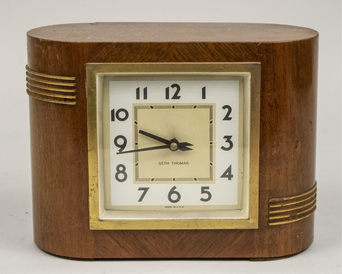 Seth Thomas Art Deco Clock: Dial with Arabic numerals. Height 7 1/2 inches. Notice to bidders: Due to the nature of this particular online sale, the lots offered may not be available for detailed condition reports or additional