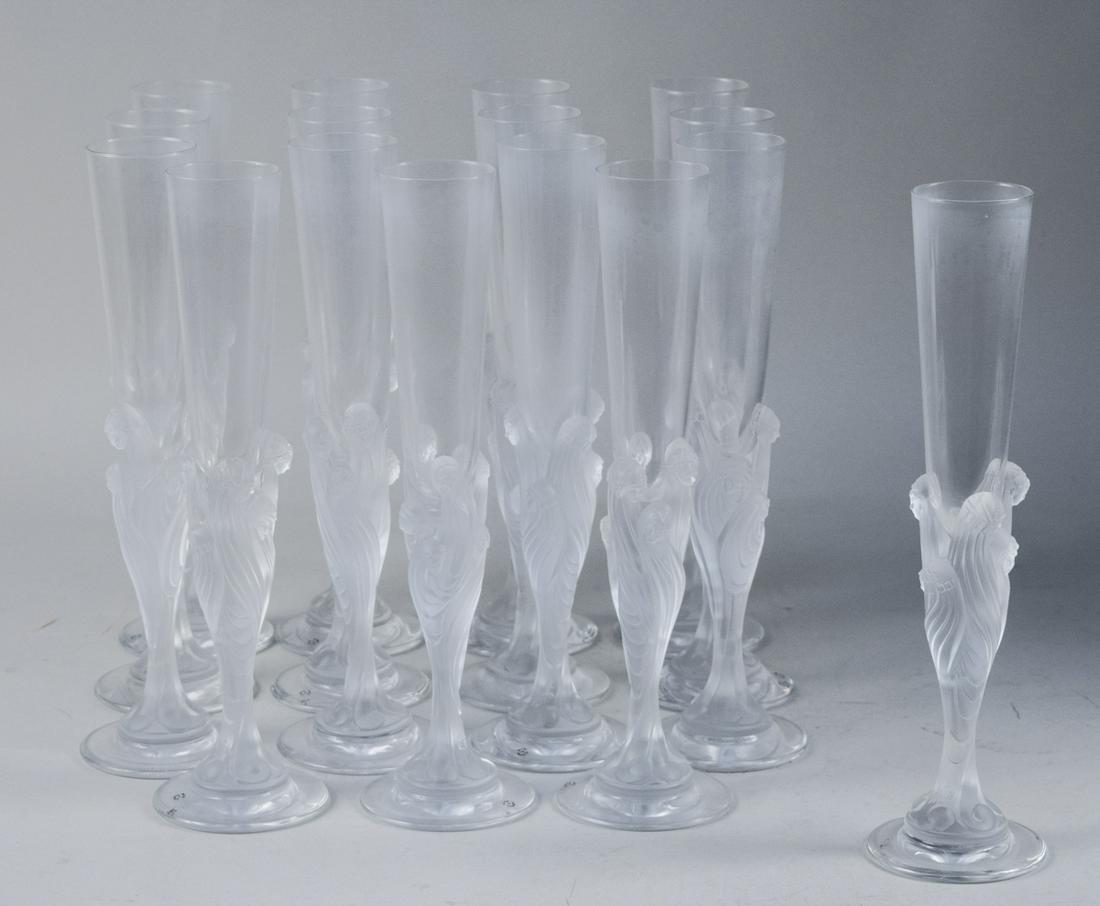 Erte (France) Champagne Flutes: Set of sixteen Flute Majestique, clear and frosted glass flutes. Height 11 3/4 inches. Notice to bidders: Due to the nature of this particular online sale, the lots offered may not be available for de