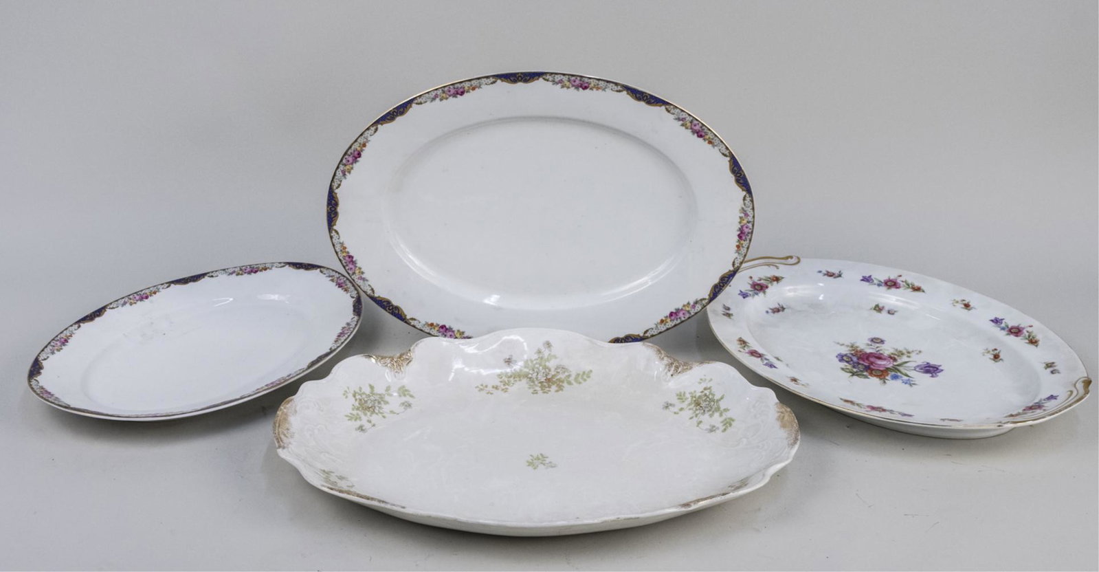 Four Ceramic Platters: Various makers and patterns. Largest, length 18 inches. Notice to bidders: Due to the nature of this particular online sale, the lots offered may not be available for detailed condition reports or add