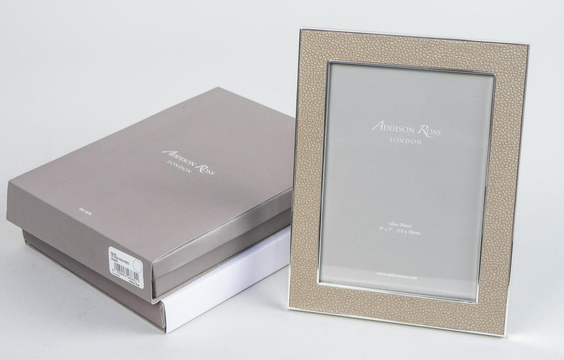 Two Addison Ross Picture Frames: Including one white enamel 5 x 7 frame and one sand shagreen 5 x 7 frame, in original boxes. Notice to bidders: Due to the nature of this particular online sale, the lots offered may not be available 