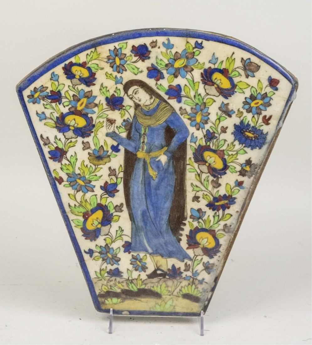 Middle Eastern Ceramic Plaque: Fan shaped plaque depicting Virgin Mary. Notice to bidders: Due to the nature of this particular online sale, the lots offered may not be available for detailed condition reports or additional photogr