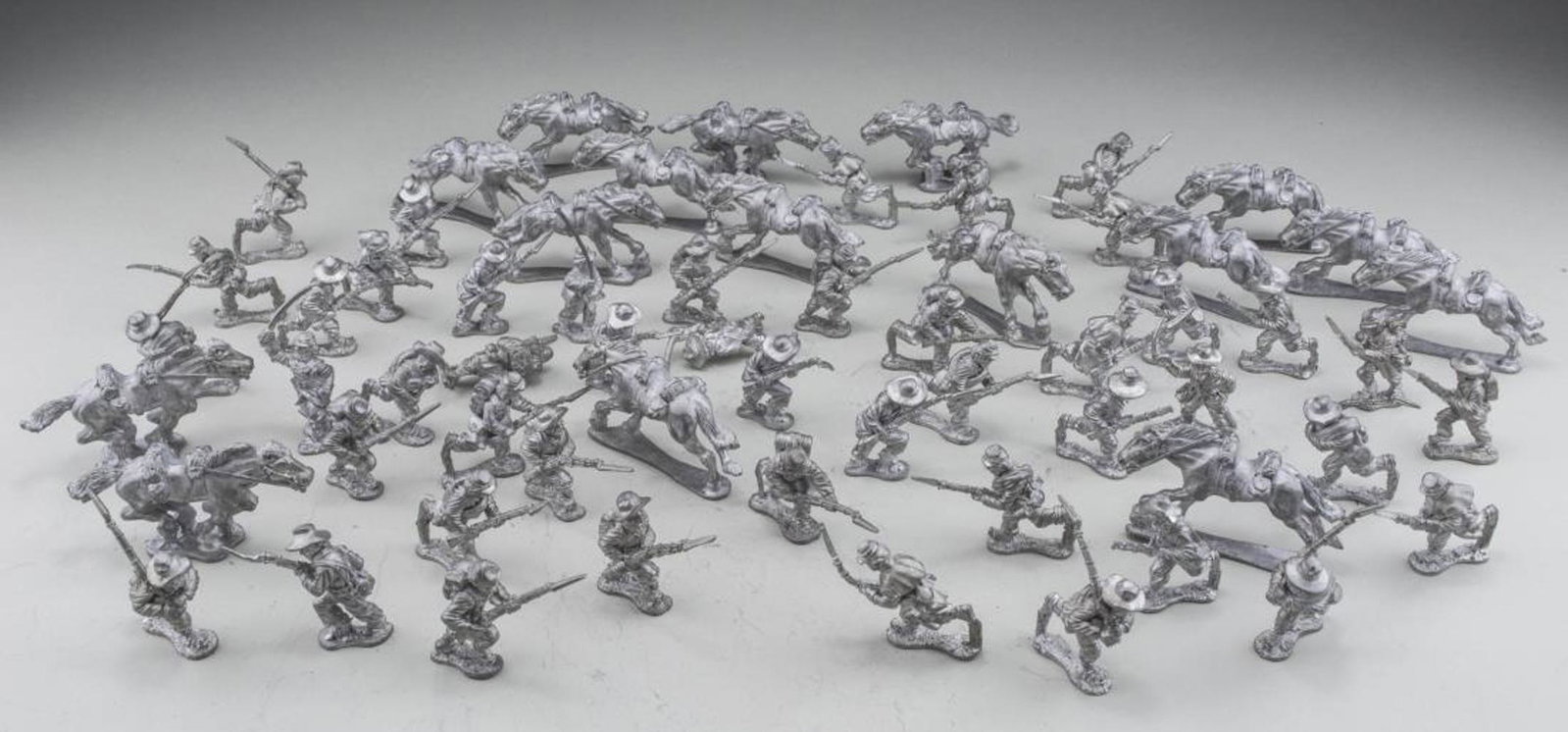 Group of Pewter Toy Soldiers: Models of civil war era soldiers, comprising forty seven infantry including a command group, fifteen cavalry soldiers and sixteen horses. Average infantry height 1 1/4 inches. Notice to bidders: Due t