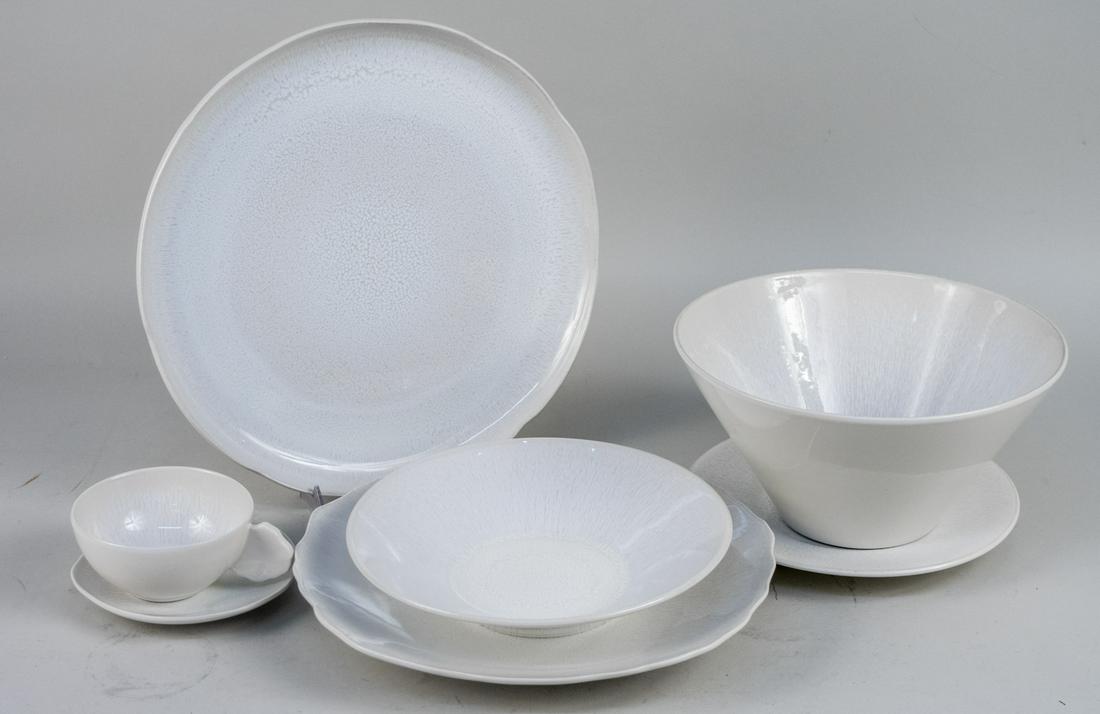 Jars Plume White Pearl Ceramic Dinner Service: Forty three pieces, comprising ten chargers, six dinner plates, one salad plate, one dessert plate, nine bowls, eight cups, seven saucers, and a round vegetable bowl. Charger diameter 12 1/8 inches. N