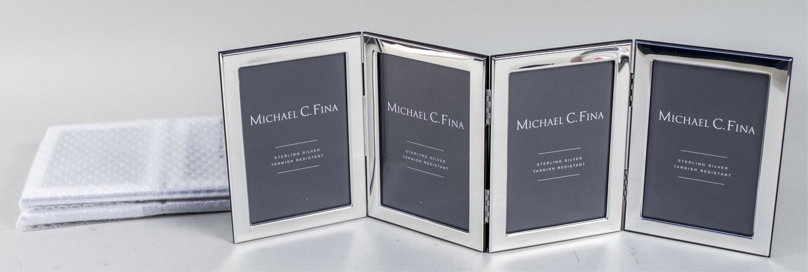 Three Zaramella Argenti Silver Picture Frames: For Michael C. Fina, each a quadruple 4 x 6 frame. Notice to bidders: Condition reports and additional photographs are provided by request as a courtesy to our clients, as such any condition report is