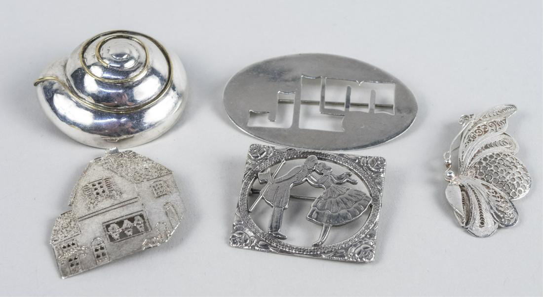 Five Sterling Silver Brooches: Various designs including a seashell, a modernist brooch, etc. Total 51.5 grams. Notice to bidders: Condition reports and additional photographs are provided by request as a courtesy to our clients, a