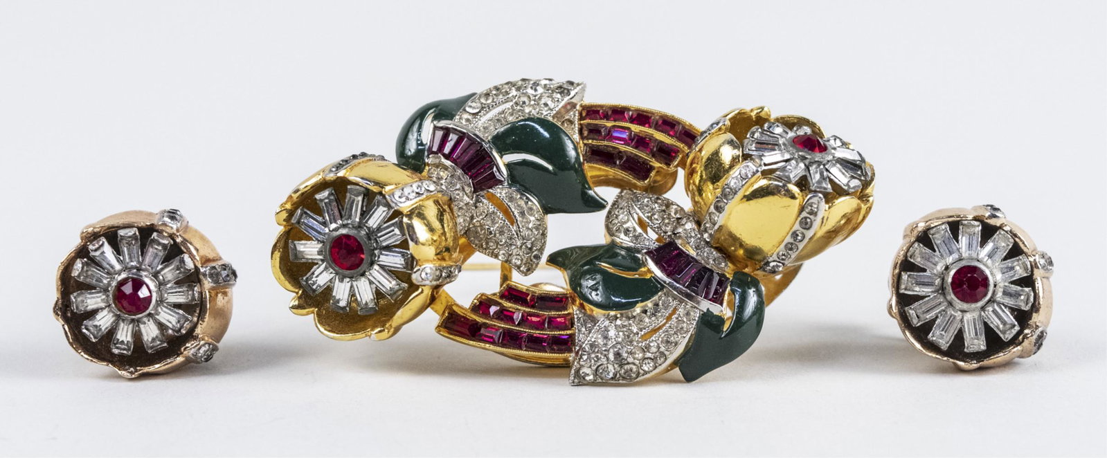 Vintage Jewelry Suite: Brooch and earrings, in the style of Cartier, an enamel decorated double clip brooch with tremblant flowers and matching screw back earrings. Clip, 2 3/4 x 1 1/2 inches. Notice to bidders: Condition r