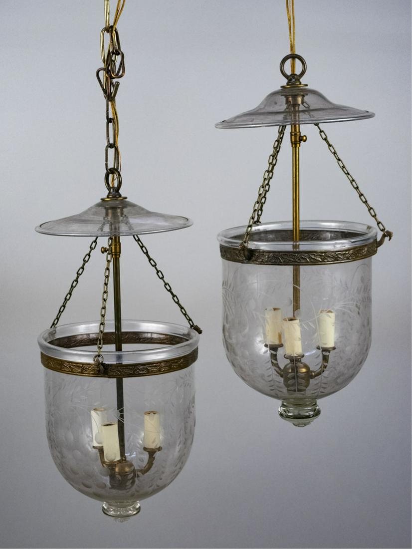 Pair of Etched Glass Bell Jar Lanterns: Height 20 inches, diameter 10 inches. Notice to bidders: Condition reports and additional photographs are provided by request as a courtesy to our clients, as such any condition report is only an opin