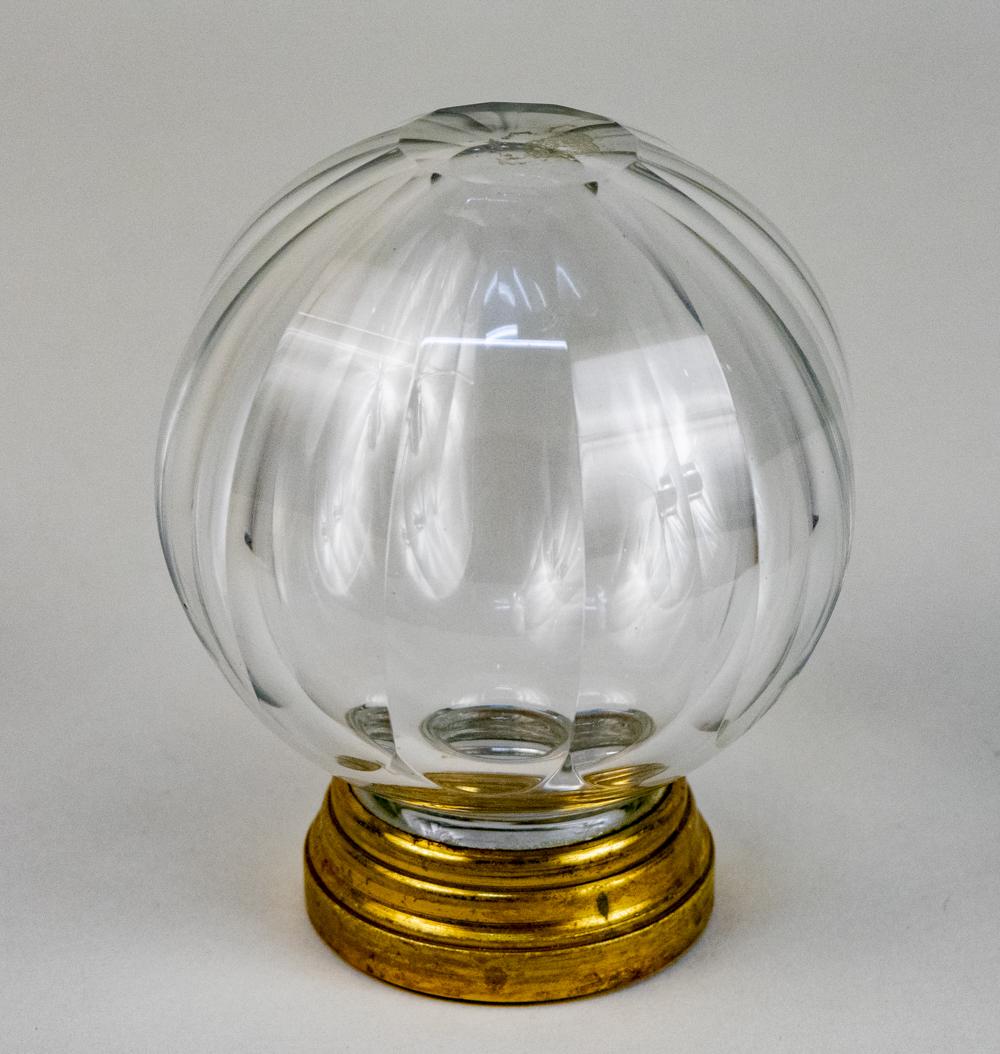 Cut Glass Newel Post: Ribbed cutting on a brass base. Height 4 3/4 inches. Notice to bidders: Condition reports and additional photographs are provided by request as a courtesy to our clients, as such any condition report 
