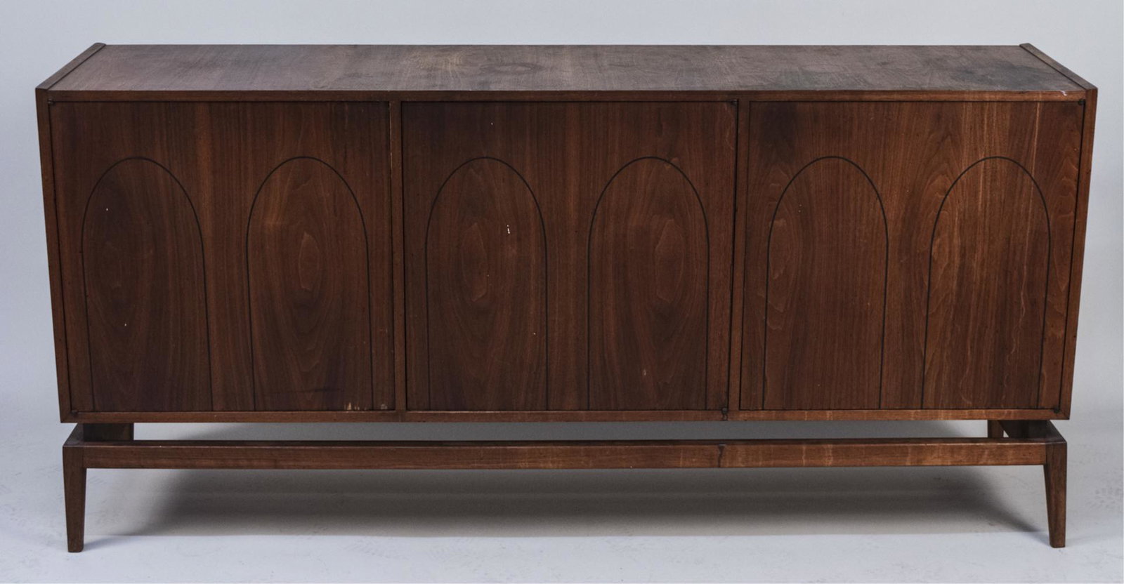 Danish Modern Teak Credenza: Rectangular top over three doors opening to shelves, on a separate base. Height 33 1/2 inches, width 6 feet. depth 18 inches. Notice to bidders: Condition reports and additional photographs are provid