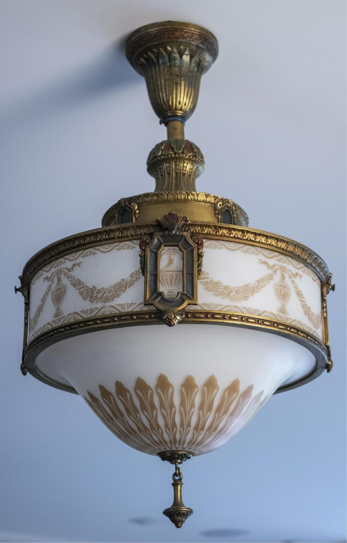 Empire Style Bronze and Glass Ceiling Fixture: Neoclassical style, with white and gold etched glass inverted dome shade with urn and floral swag decoration. Diameter 15 inches, height of glass shade 10 1/2 inches. Notice to bidders: Condition repo