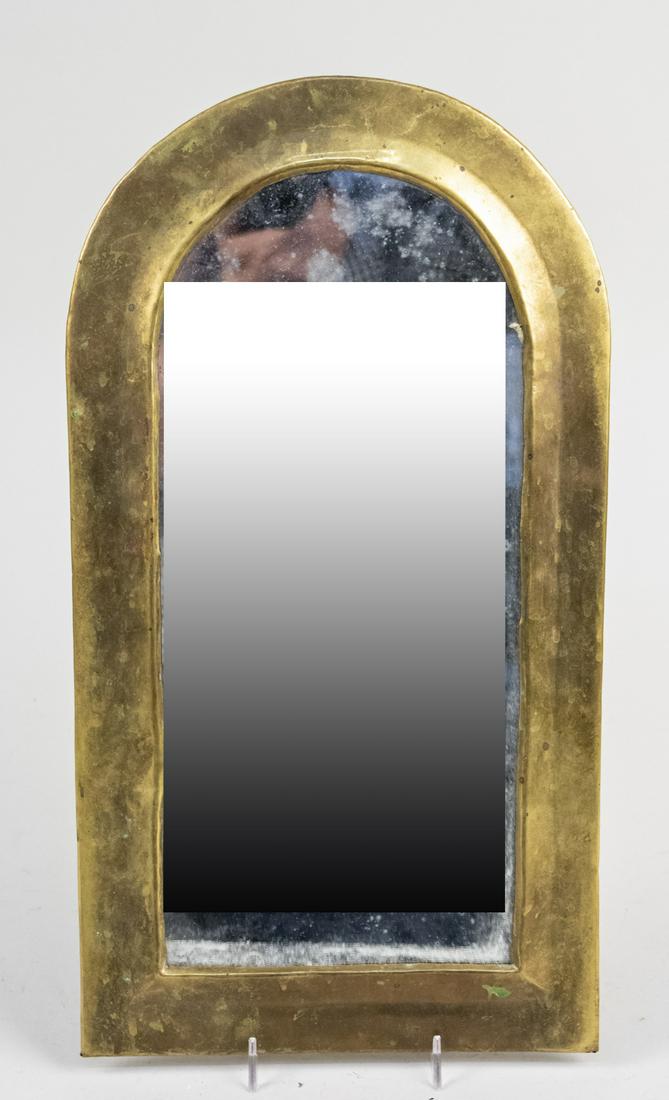 Brass Mirror: Arched top rectangular mirror in brass frame. Height 17 1/4 inches, width 9 1/2 inches. Notice to bidders: Condition reports and additional photographs are provided by request as a courtesy to our cli
