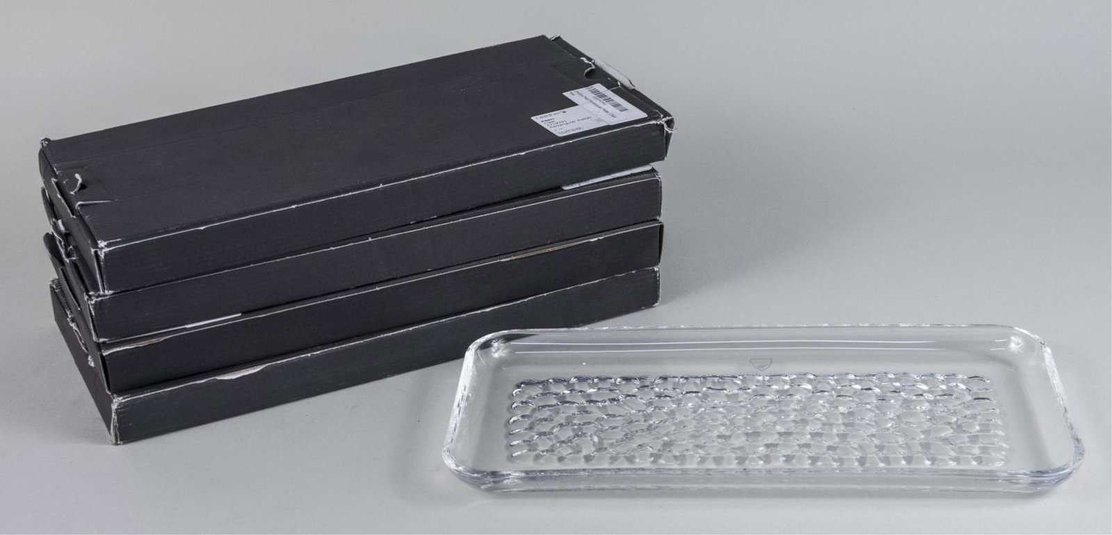 Four Orrefors Pearl Rectangular Platters: New in original box. Length 13 inches. Notice to bidders: Due to the nature of this particular online sale, the lots offered may not be available for detailed condition reports or additional photograp
