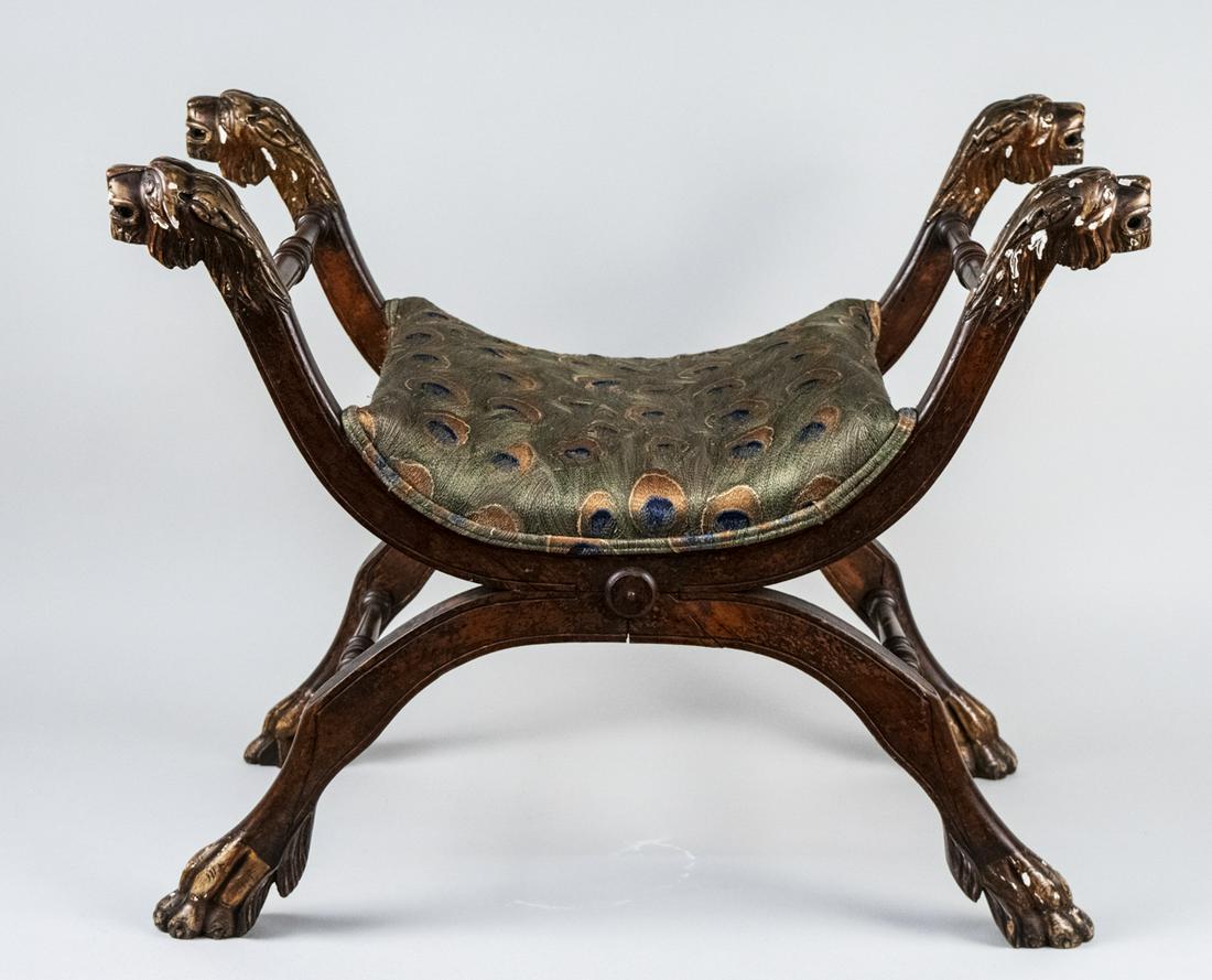 Italian Curule Bench *: 18th century, parcel gilt bench with lion head finials and paw feet, the seat with peacock pattern silk upholstery. Height 24 inches, width 30 inches, depth 18 inches. Notice to bidders: Due to the na