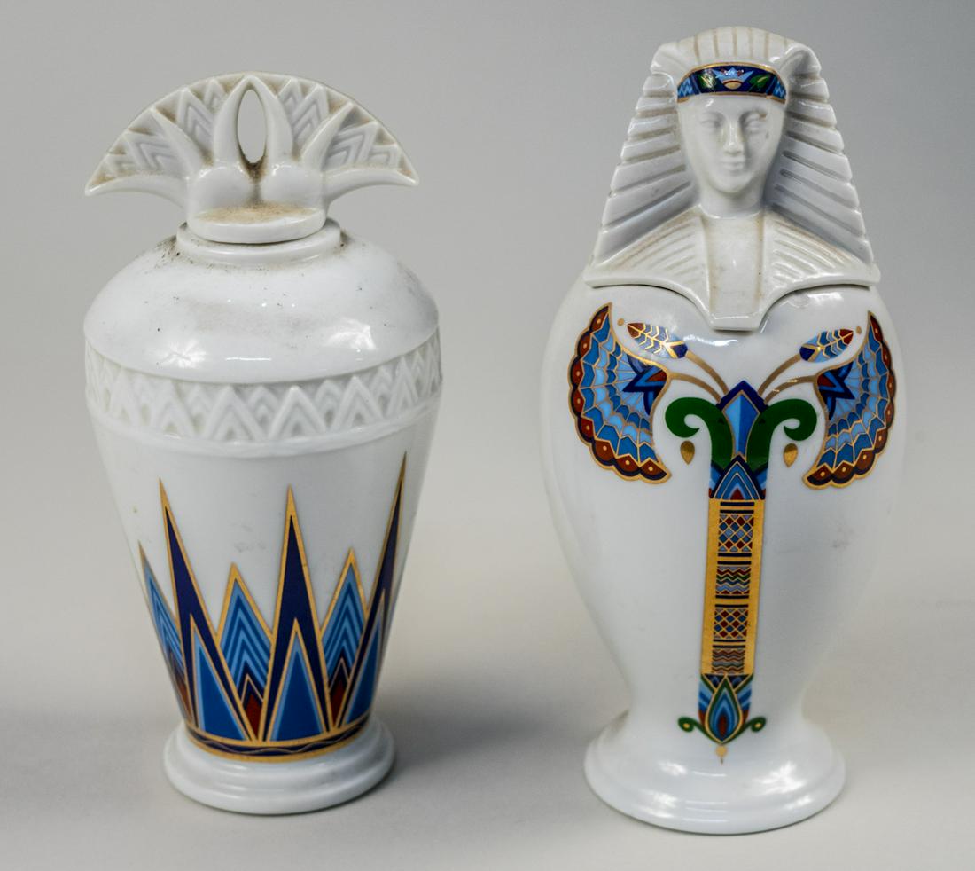 Two Elizabeth Arden Porcelain Articles: Two jars from the Treasures of the Pharaohs collection, one a take on a canopic jar, the other a jar with a stopper. Taller height 7 1/2 inches. Notice to bidders: Condition reports and additional pho