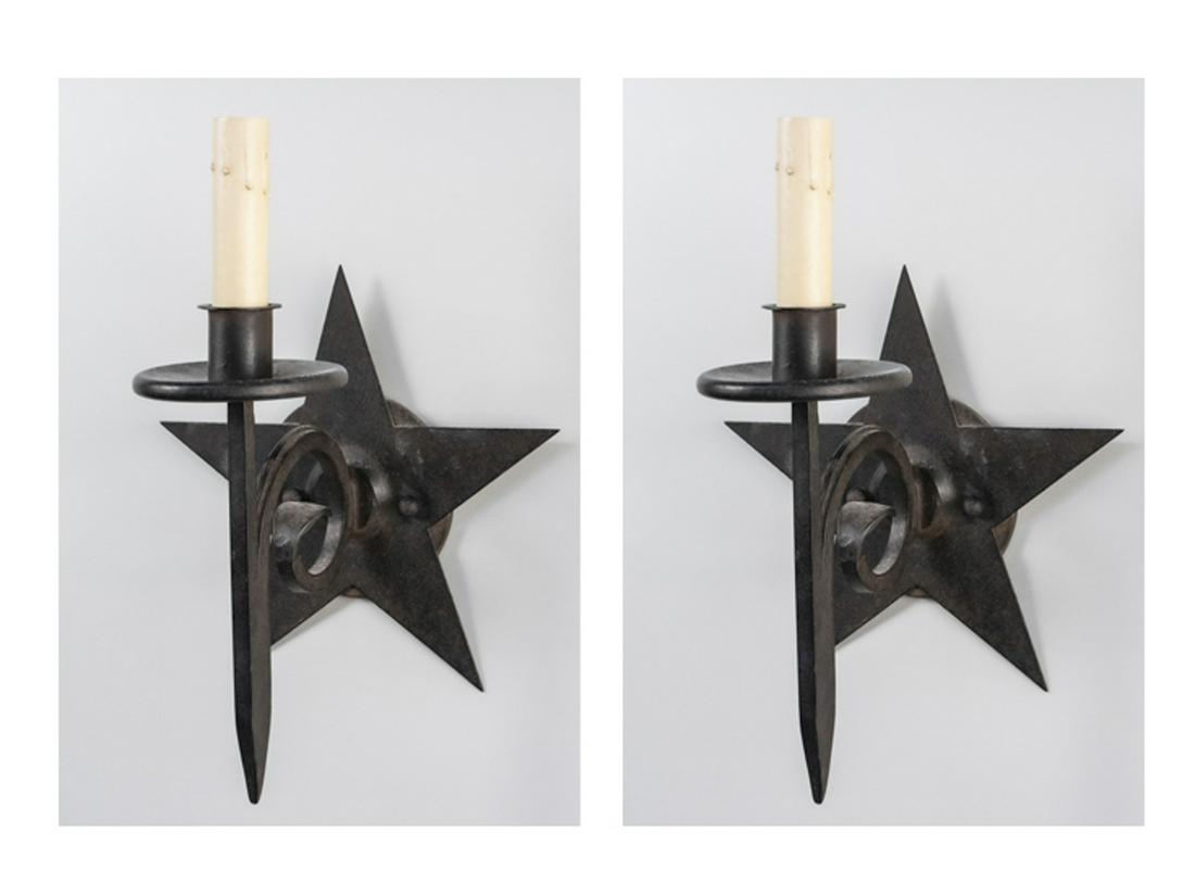 Pair of Iron Sconces: Star decoration. Height 17 inches. Notice to bidders: Condition reports and additional photographs are provided by request as a courtesy to our clients, as such any condition report is only an opinion
