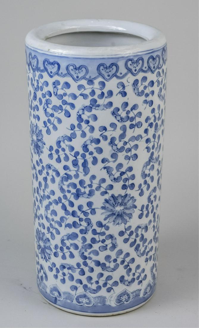 Porcelain Umbrella Stand: Cylindrical with all around scrolled flower decoration. Height 18 inches. Notice to bidders: Condition reports and additional photographs are provided by request as a courtesy to our clients, as such 