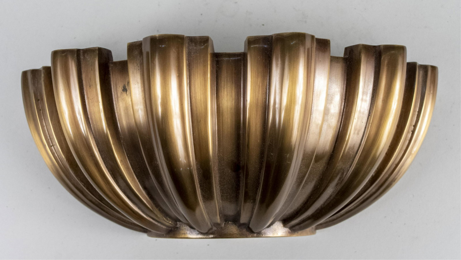 Brass Shell Form Wall Light: Height 5 inches, width 11 3/4 inches. Notice to bidders: Due to the nature of this particular online sale, the lots offered may not be available for detailed condition reports or additional photograph