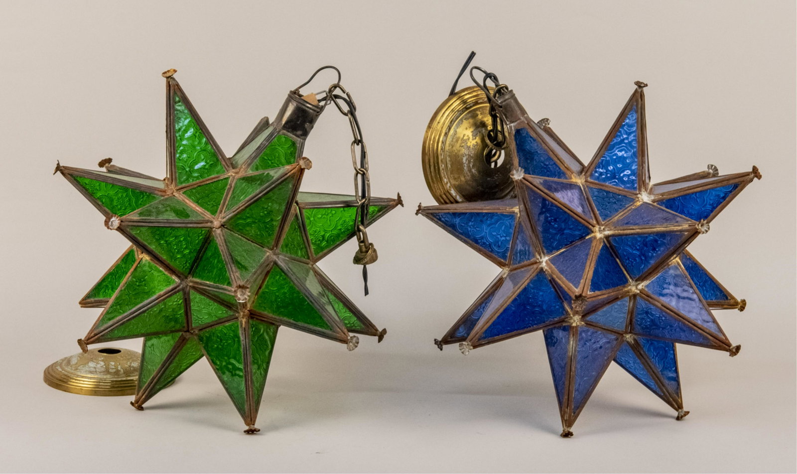 Two Pendant Lights: Stellar shaped lights, one blue and one green glass. Height 16 inches. Notice to bidders: Due to the nature of this particular online sale, the lots offered may not be available for detailed condition