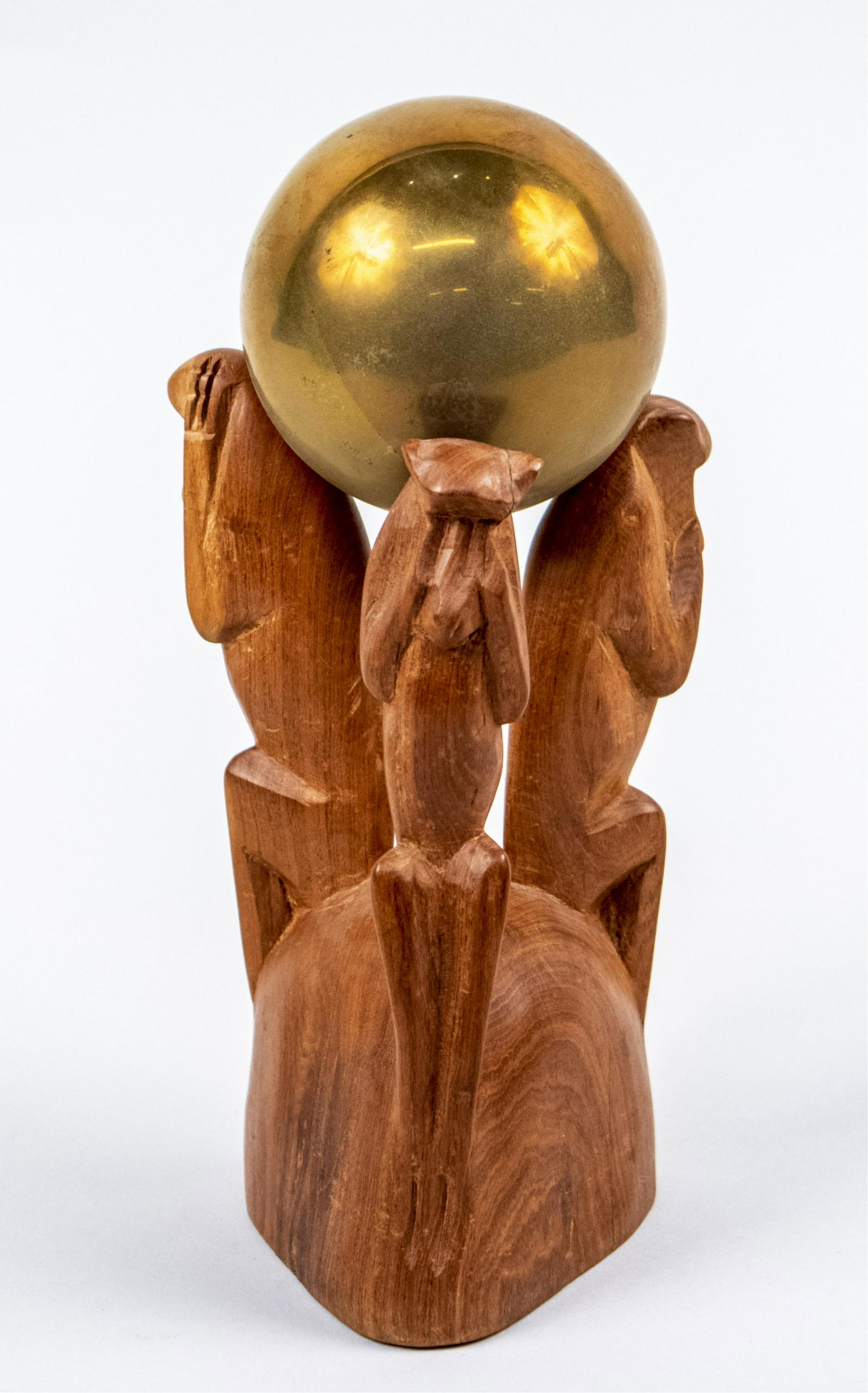 African Carved Wood Monkey Centerpiece: With a brass orb held aloft by a carved wood base with three monkey (possibly baboon) form supports in the likeness of hear, speak and see no evil, hand carved in Kenya label on base. Height overall 9