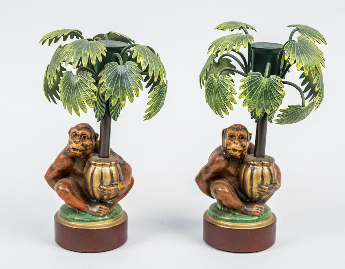 Pair of Petites Choses Tole Candle Holders: Each modeled as a monkey holding a palm tree in a planter. Height 7 3/4 inches. Notice to bidders: Due to the nature of this particular online sale, the lots offered may not be available for detailed 