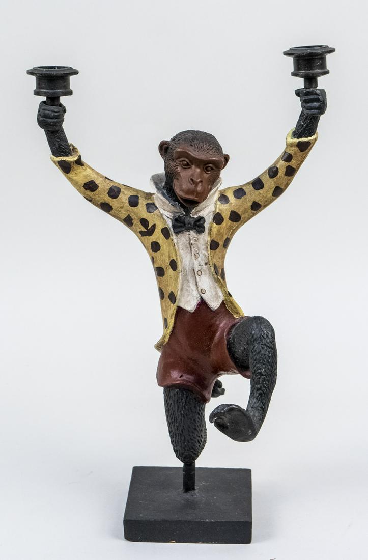 Scully & Scully Cold Painted Cast Iron Candleabra: Prancing monkey in a fancy spotted coat and shorts holding a candle cup in each hand. Height 15 inches. Notice to bidders: Due to the nature of this particular online sale, the lots offered may not be