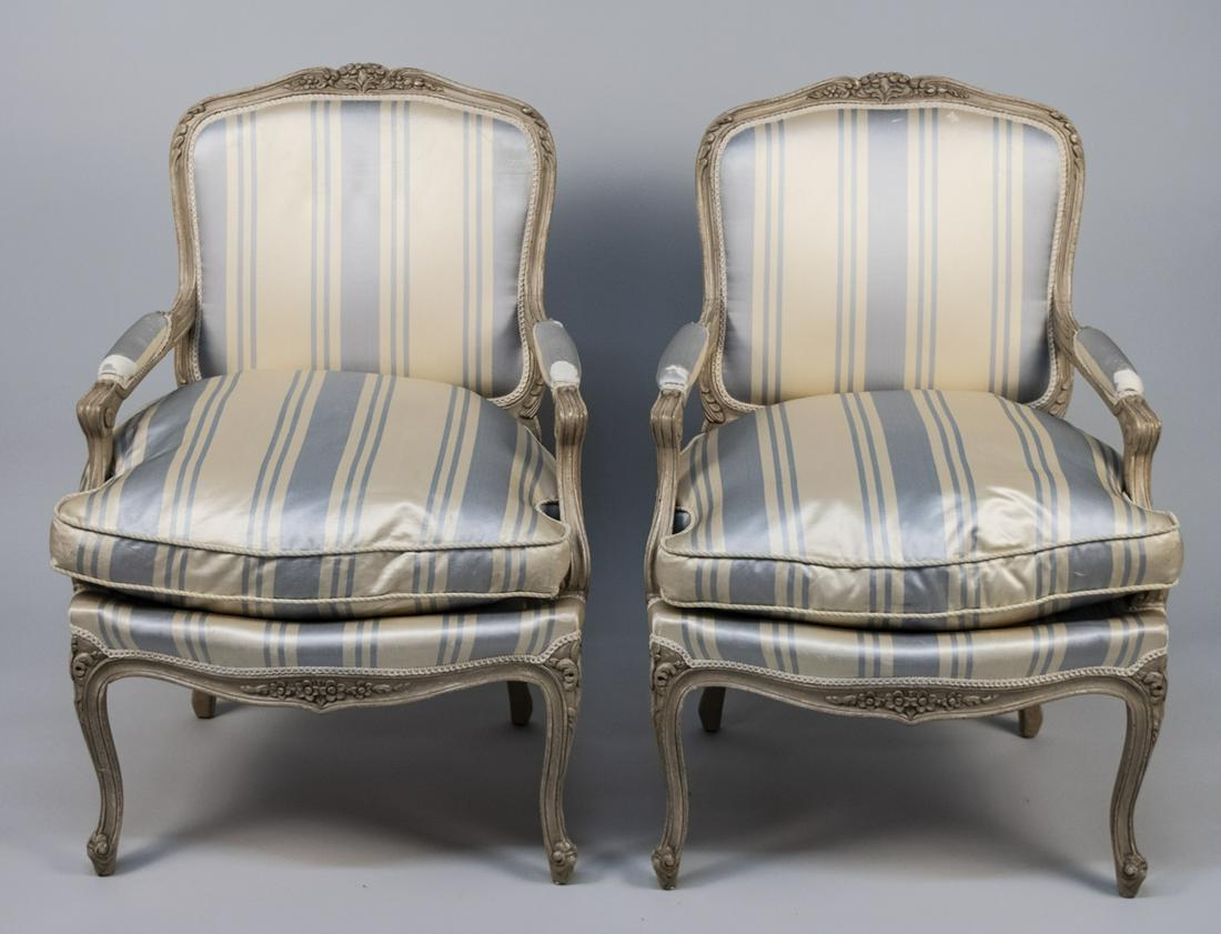 Pair of Auffray & Co. Louis XV Style Fauteuils: Cream painted, with satin striped upholstered back arms and seat, on cabriole legs. Height 37 inches, width 25 inches, depth 27 inches. Notice to bidders: Due to the nature of this particular online s
