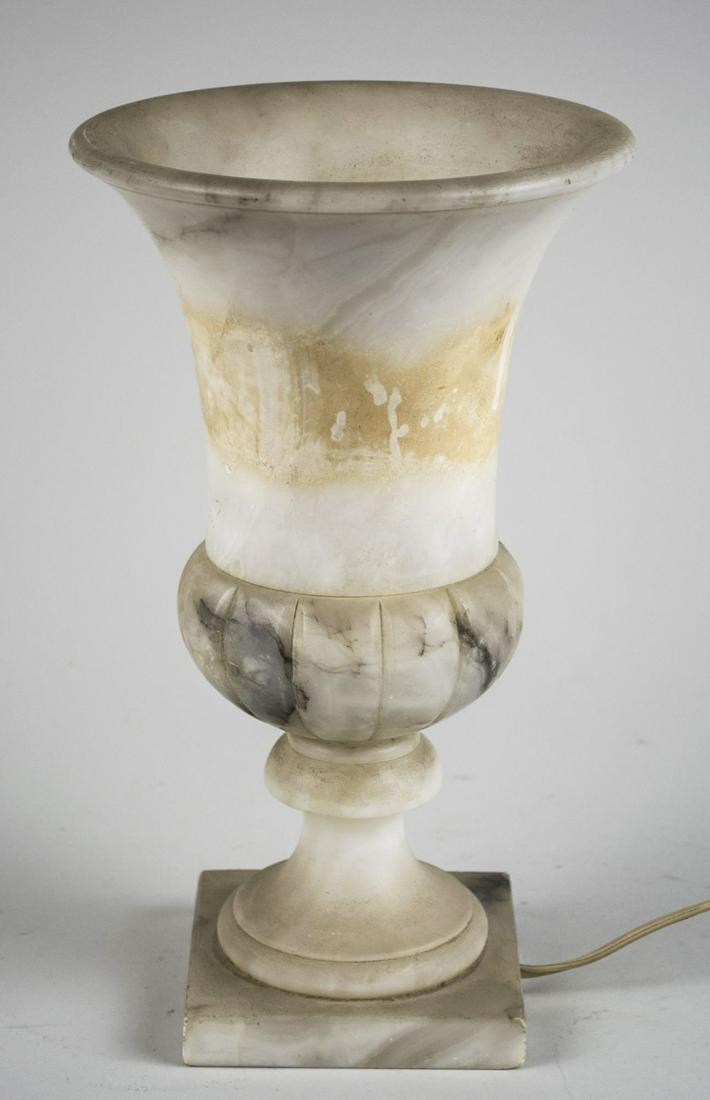 Art Deco Alabaster Lamp: Campagna form lamp, electrified. Height 11 3/4 inches. Notice to bidders: Condition reports and additional photographs are provided by request as a courtesy to our clients, as such any condition repor