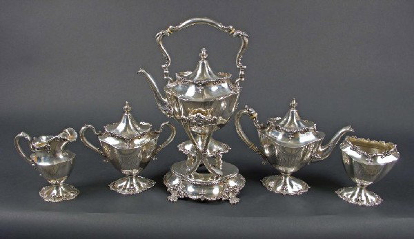 Sterling Silver Tea Service: Mauser Silver Co. comprising a kettle on stand, teapot, covered sugar bowl, milk jug, and waste bowl. Total approximately 80 ounces. Height of kettle on stand inches.