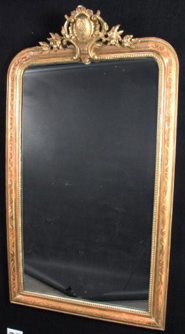 Louis XV Style Gilt Wood Mirror The mirror plate i: Louis XV Style Gilt Wood Mirror The mirror plate is surmounted by a central cartouche flanked by flower, scroll and shell carvings, above a bead and convex molded frame. Height 65 inches, width 37 inc