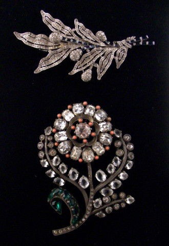 Eisenerg and Trifari Jewelry: Two magnificent flower brooches comprising an Eisenberg flower with simulated coral and accents and green stone leaves, together with a Trifari floral spray with blue stone accents.