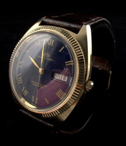 Bucherer Wristwatch: Man's gold plated wristwatch, lapis dial with Roman numerals and date aperture, self winding movement, leather band.