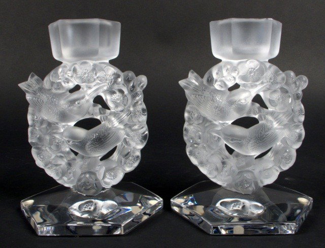 Pair of Lalique 'Mesanges' Candlesticks: Molded glass candlesticks, each with pair of birds within a wreath of flowers, hexagonal base and bobeche. Height 7 inches.Ref. Felix Marcilhac, Rene Lalique 1860-1945, page 612.