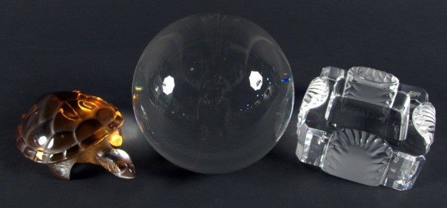 Three Glass Decorations: Lalique amber frog and colorless square dish together with a crystal ball. Ball diameter 5 inches.