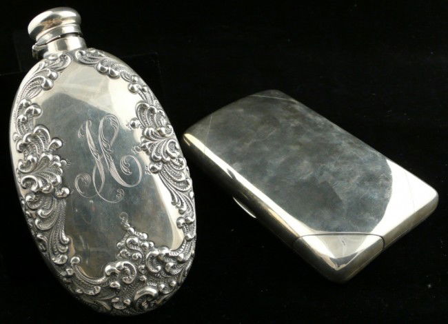 Two Gorham Sterling Silver Flasks: One, oval with repousse scroll decoration, monogrammed 'H' and the other, rectangular with a corner twist open tab. Total approximately 10 ounces.
