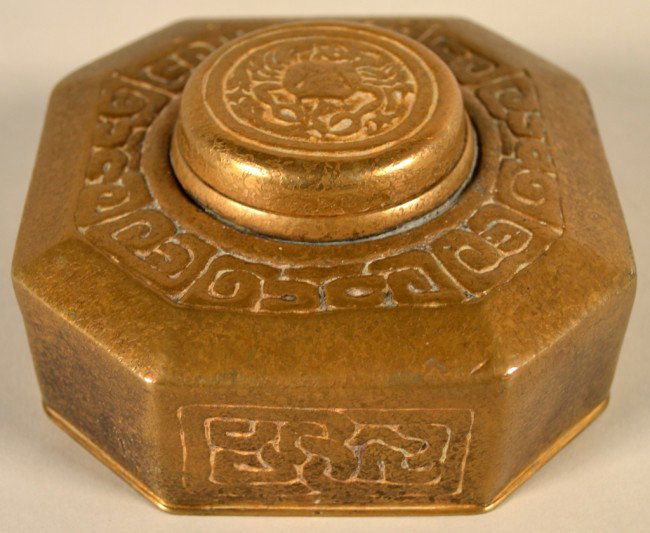 Tiffany Gilt Bronze Zodiac Inkwell: Octagonal inkwell decorated with Sign of Cancer (Crab) on the cover, signed on the bottom, "Tiffany Studios/New York/842" Height 2 1/4 inches, width 4 inches, depth 4 inches.