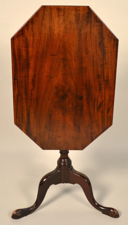 George III Style Mahogany Tilt Top Table: Octagonal top on urn form standard on three scrolled legs. Height 26 inches, width 26 inches, depth 18 inches.