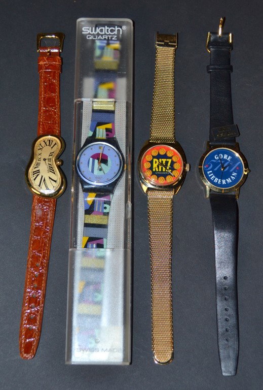 Four Novelty Watches in Boxes: Comprising a GORE / LIBERMAN campaign watch, a Softwatch, a Swatch watch and a LeJour RITZ watch, all in original box.