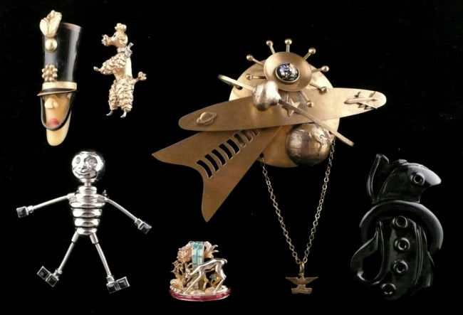 Six Novelty Pins: Comprising a Panetta Poodle pin, a Coro deer pin, a Beefeater pin, carved jet pin, and two space pins.