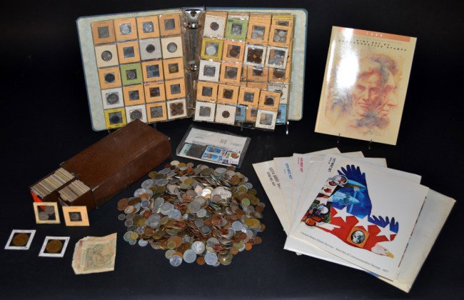 Miscellaneous Group of Coins & Stamps: Stamps are US Postal Souvenir Mint sets 1972,1973, 1976, 1977, 1985,1987 etc.; together with a large collection of coins of the World.