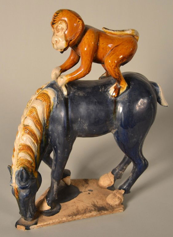 Tang Style Horse with Monkey: Sancai glazed figure of a Tang style horse with a monkey riding on its back. Height 16 inches.