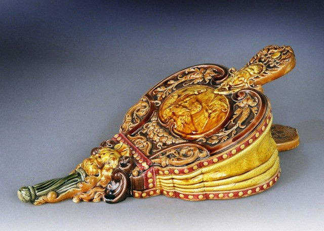 Majolica Wall Pocket: Modelled in the form of a bellows, with scroll and mask decoration. Height 21 inches.