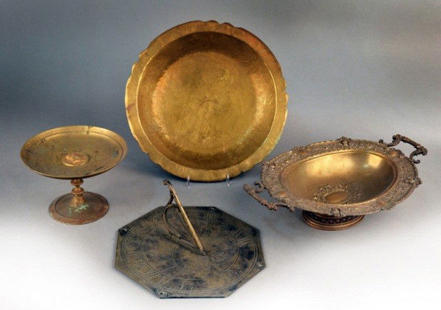 Miscellaneous Group of Brass Decorations: Comprising shallow center bowl, a tazza, a sundial and a two handled oval compote. Bowl, diameter 13 1/2 inches.