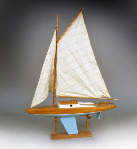 Wood Model of a Sailboat: On a wood stand. Height on stand with sail 31 inches.