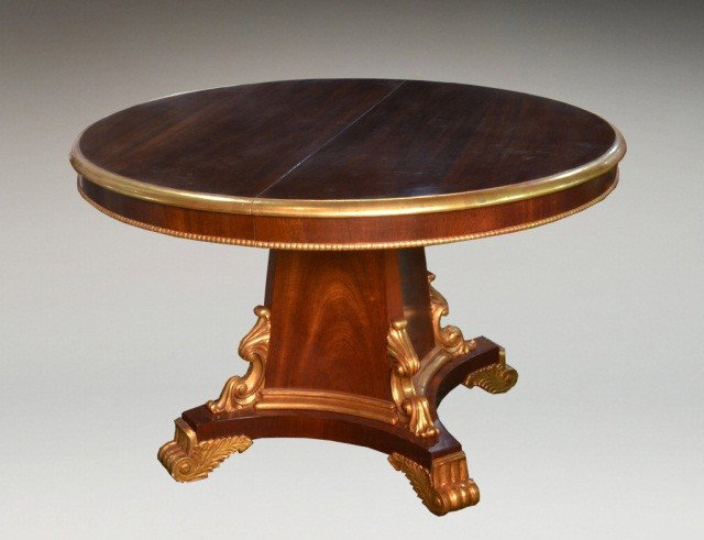Dining Table: William IV style, parcel gilt, mahogany table. Includes one additional leaf. Height 31 inches, diameter 50 inches.