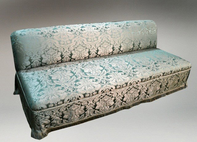 Pair of Green Damask Sofas: Each green damask upholstered armless sofa with fringe bottom. Height 31 inches, length 7 feet, depth 36 inches.