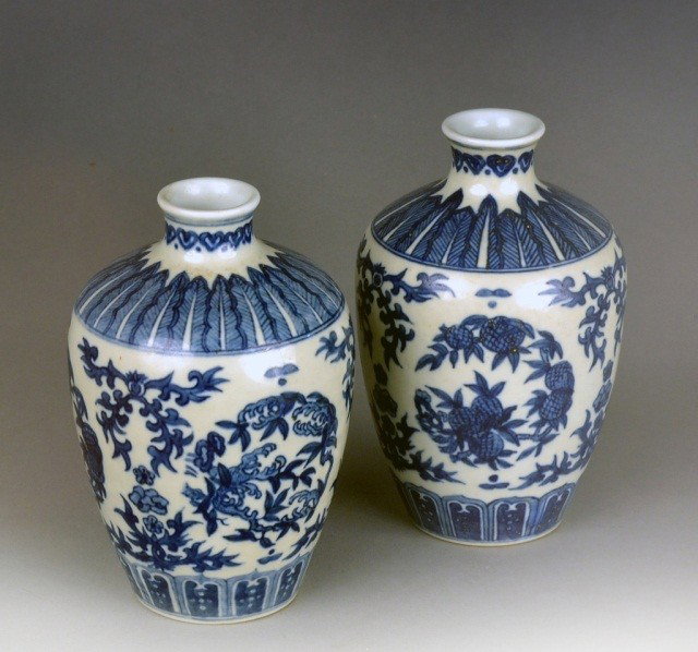 Pair Asian Blue and White Porcelain Vases: Ovoid, each with leaf decorated shoulder, stylized floral and foliate decoration and diaper base. Height 7 inches.