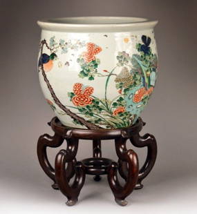 Chinese Porcelain Fish Bowl: Decorated with flowers and a bird. Height 16 inches, diameter 18 inches.