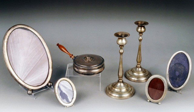 Assorted Silver and Silver Plated Articles: Including a pair of silver plated candlesticks, sterling silent butler and four sterling picture frames. Height of candlesticks 9 1/4 inches.
