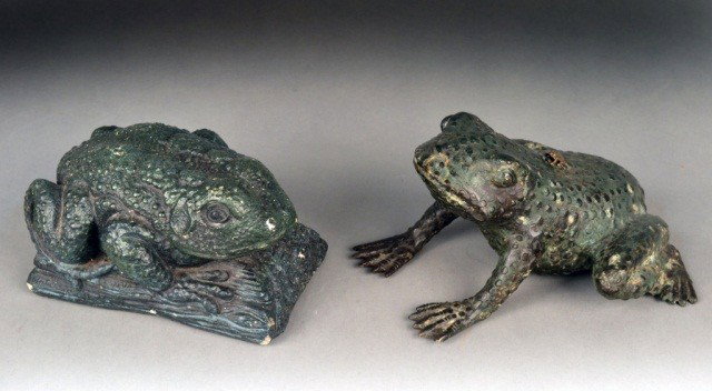 Two Frog Door Stops: Patinated metal and composition examples. Taller 4 3/4 inches.